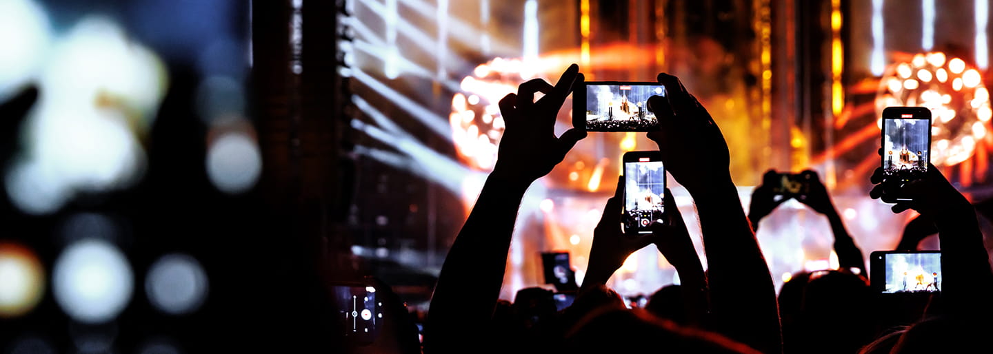 Croad using mobile phones to take pictures at a concert